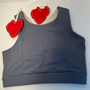 Two bralettes size S .  1 tan shiny material.  1 grey w/yellow & white straps